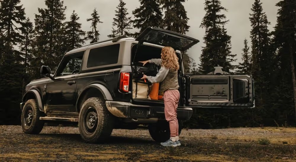 Black 2026 Ford Bronco with a woman loading the trunk