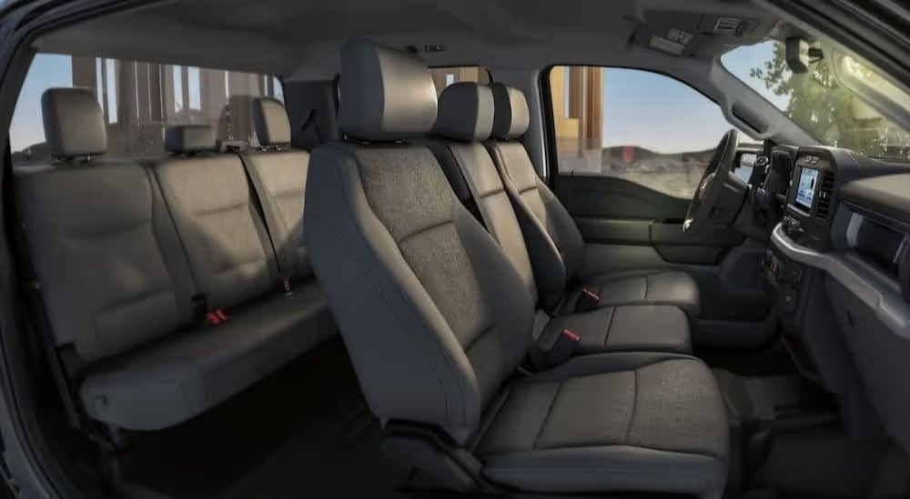 The gray interior and dash of a 2023 Ford F-150 for sale is shown.