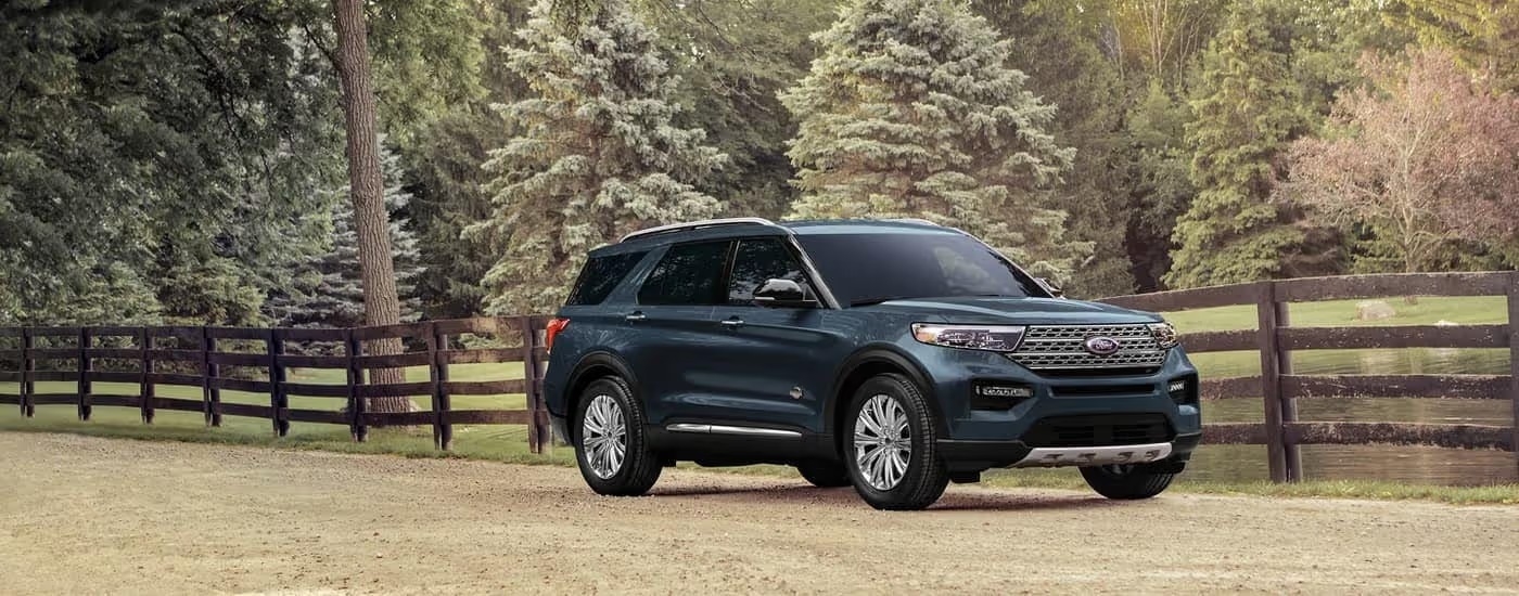 A blue 2023 Ford Explorer King Ranch is shown from the side at an angle.