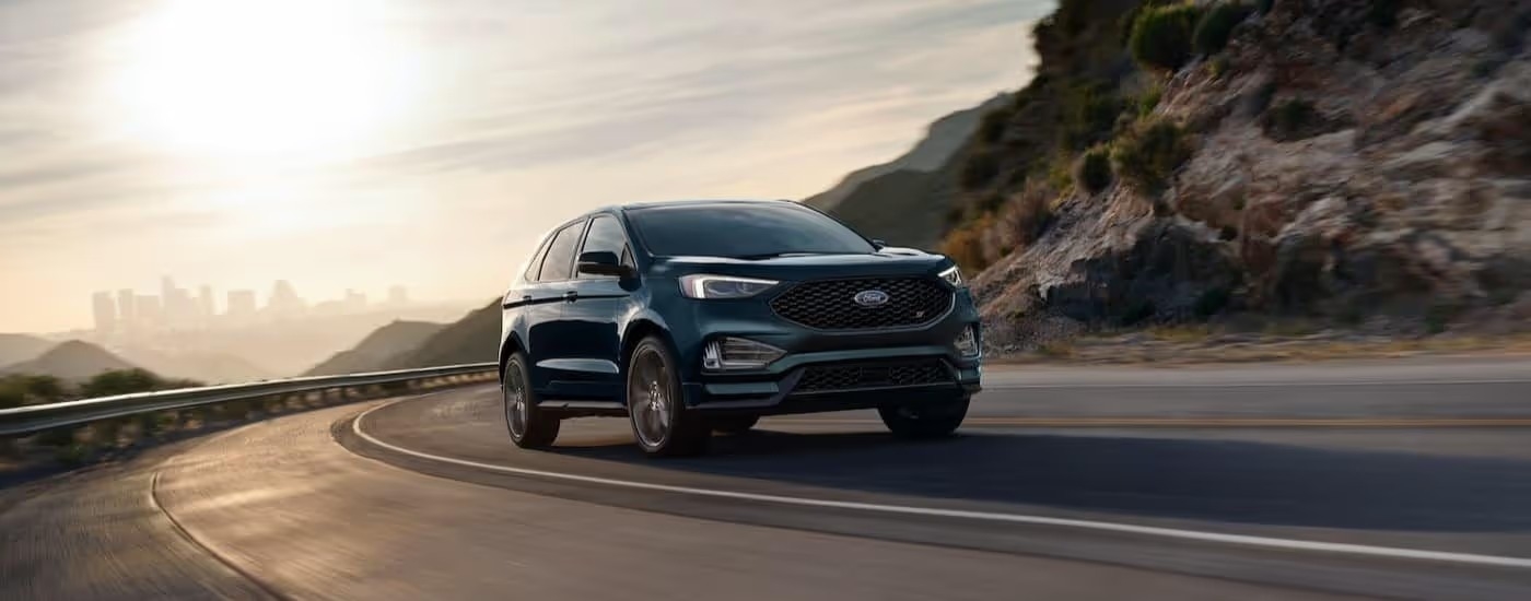 A green 2024 Ford Edge is shown driving on a highway.