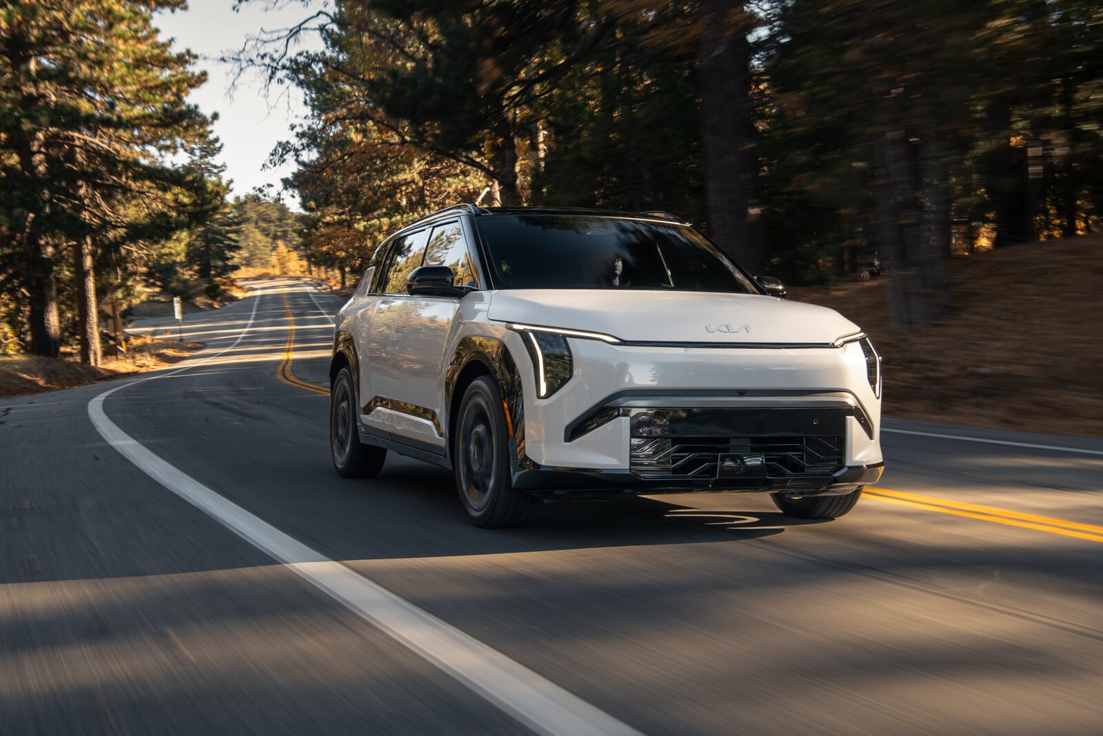 The upcoming Kia EV3 electric SUV parked driving on the road