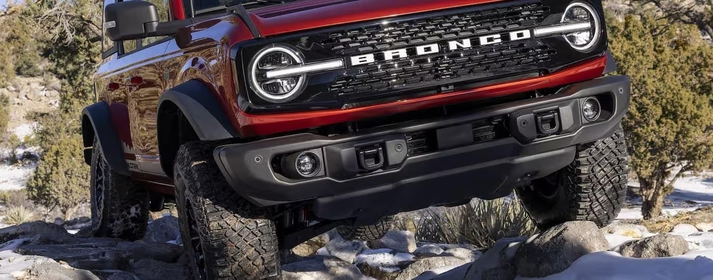 A close up of a red 2024 Ford Bronco Wildtrak off-roading is shown.