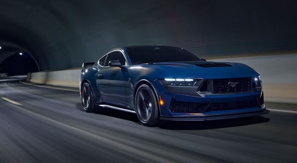 Blue 2024 Ford Mustang Dark Horse Premium driving in a tunnel