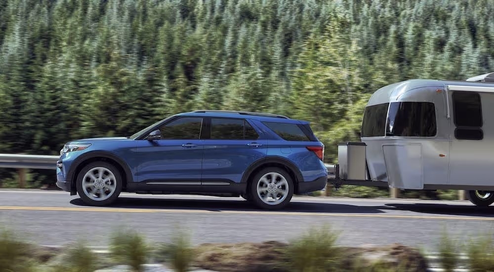 A blue 2021 Ford Explorer is shown towing an Airstream trailer after leaving a used Ford dealer near Sandy Springs, GA.