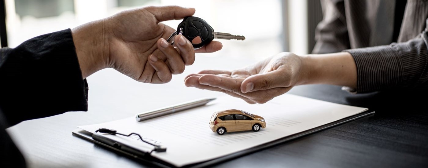 A service advisor handing keys back to an owner.