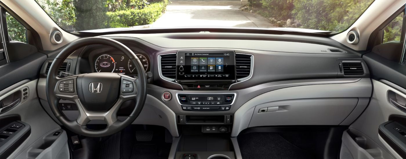 Interior view of a 2026 Honda Ridgeline infotainment and steering wheel.