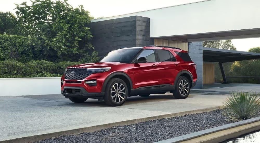 A red 2024 Ford Explorer is shown parked in a driveway.