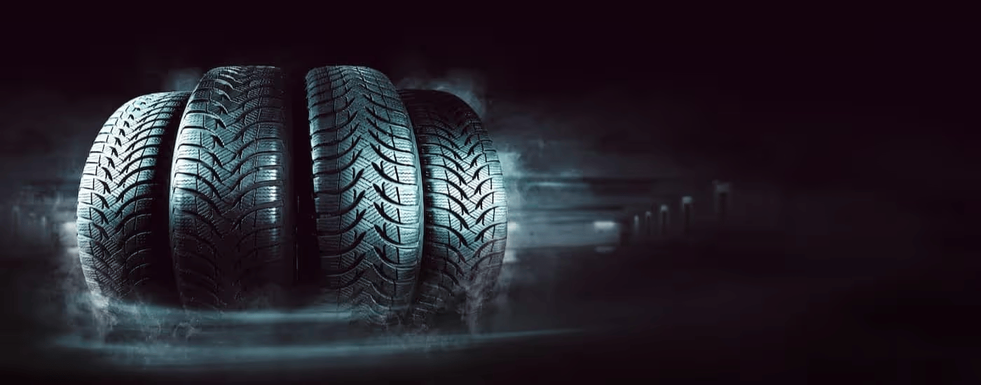 Four tires are shown lined up side by side.