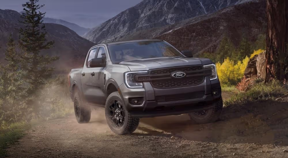 A grey 2025 Ford Ranger Lariat parked off-road on a mountain.