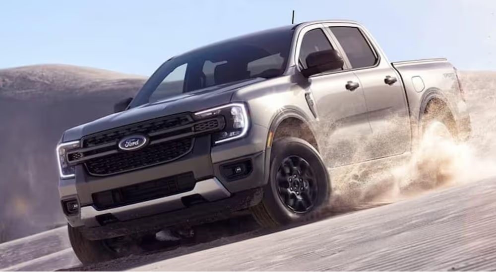 A silver 2024 Ford Ranger is shown driving off-road.