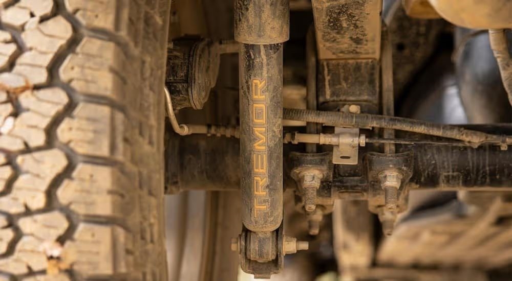 A close up of the rear shock of a 2024 Ford F-150 Tremor is shown on a lifted truck.