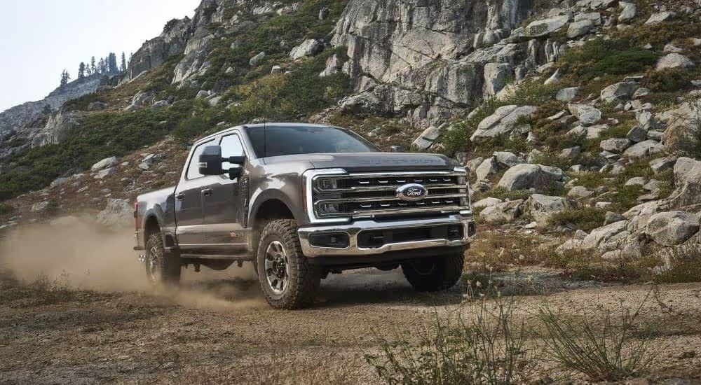 A gray 2023 Ford F-150 Tremor is shown driving off-road.