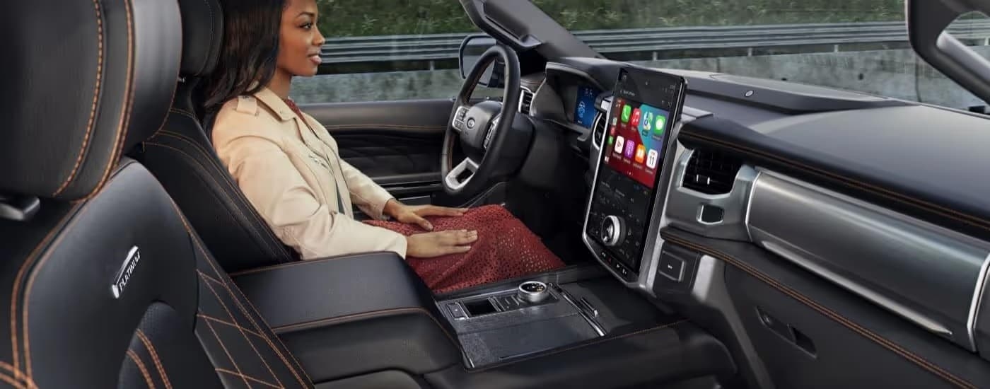 A person driving in a 2023 Ford Expedition.