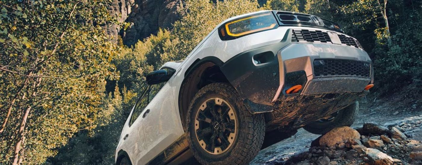 White 2026 Honda Passport driving up a rock pile.