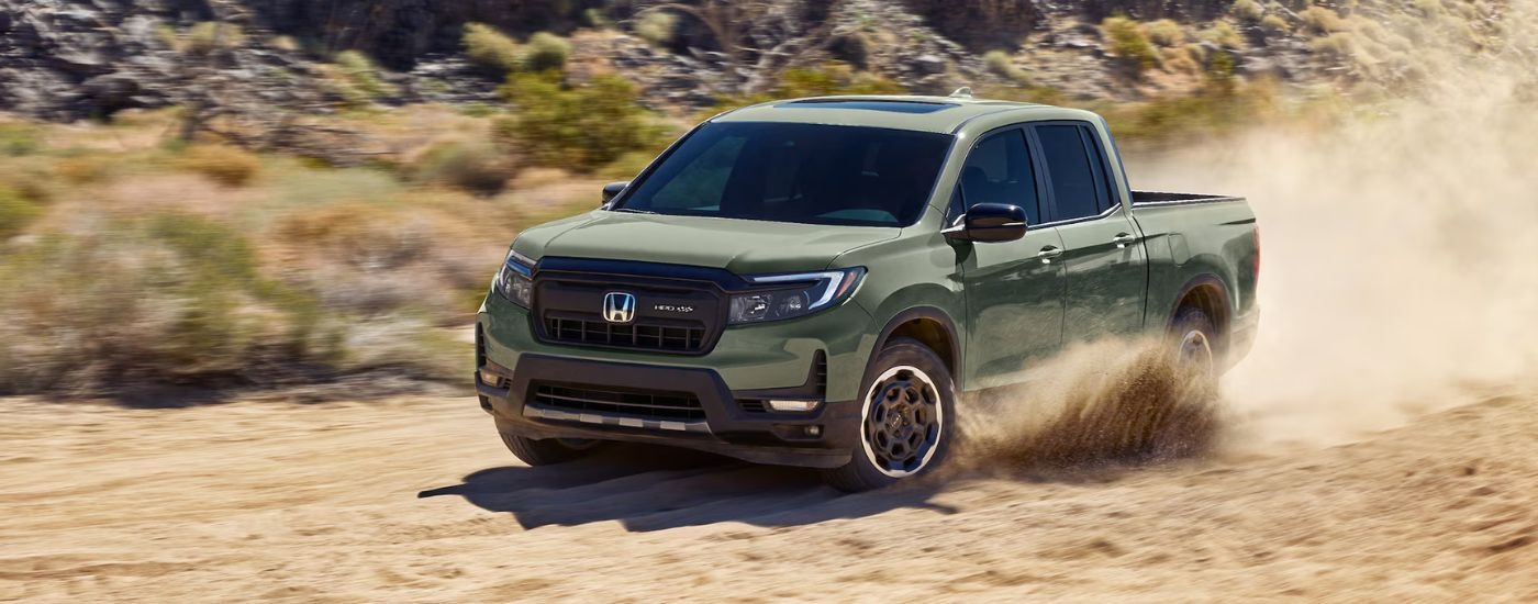 Green 2026 Honda Ridgeline driving off-road.