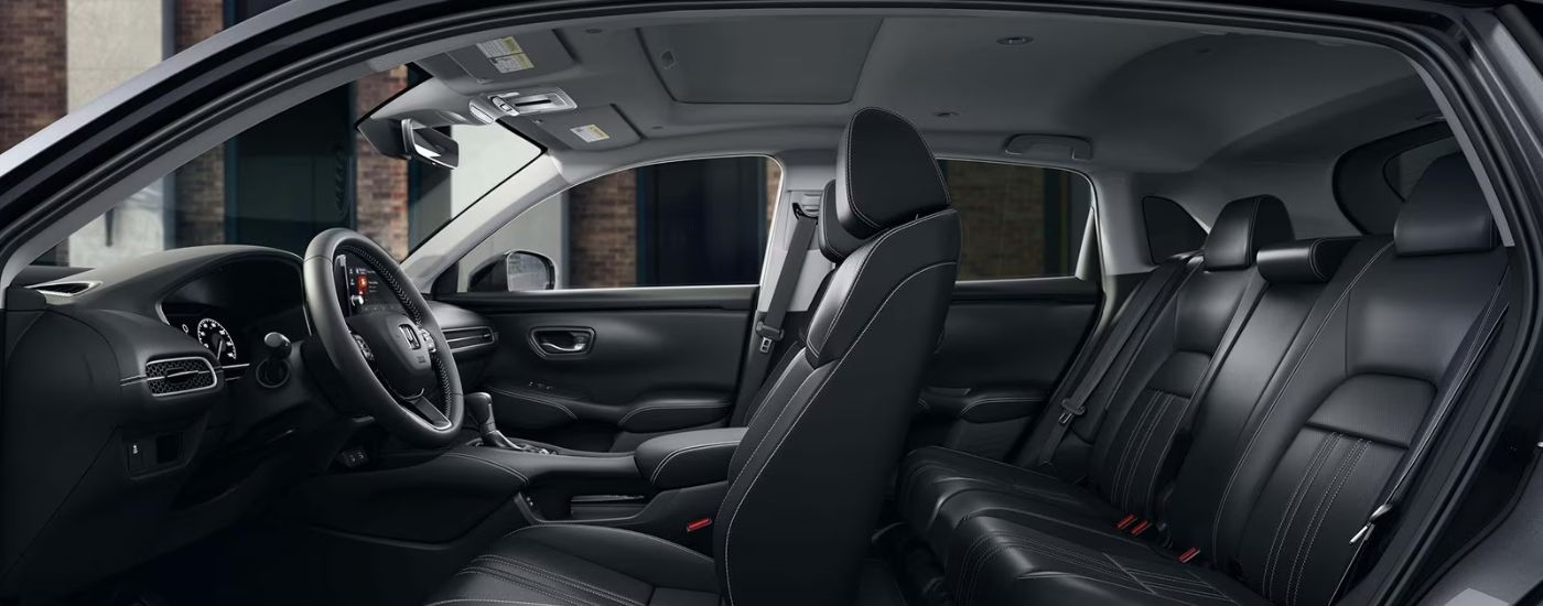 Cross-section view of the interior of a 2027 Honda HR-V with black leather seats.