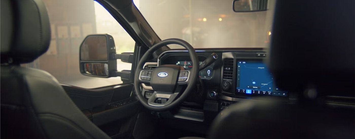 2026 Ford Super Duty front interior showing the steering wheel and driver's seat.