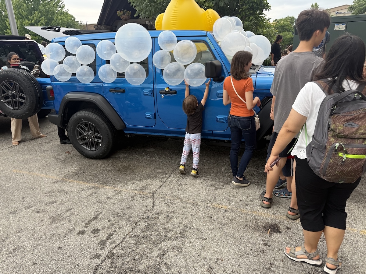 Families enjoying the Castle CDJR Naperville Jeep display