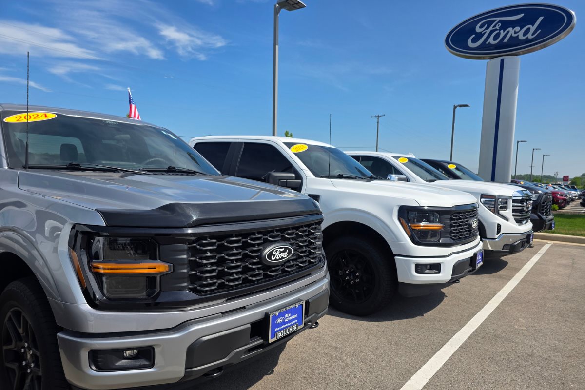 Used Ford trucks displayed on the Boucher Ford Kenosha dealership lot.