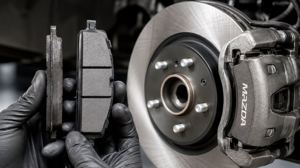 Mazda brake rotor and caliper during a brake inspection at a Miami Mazda service center
