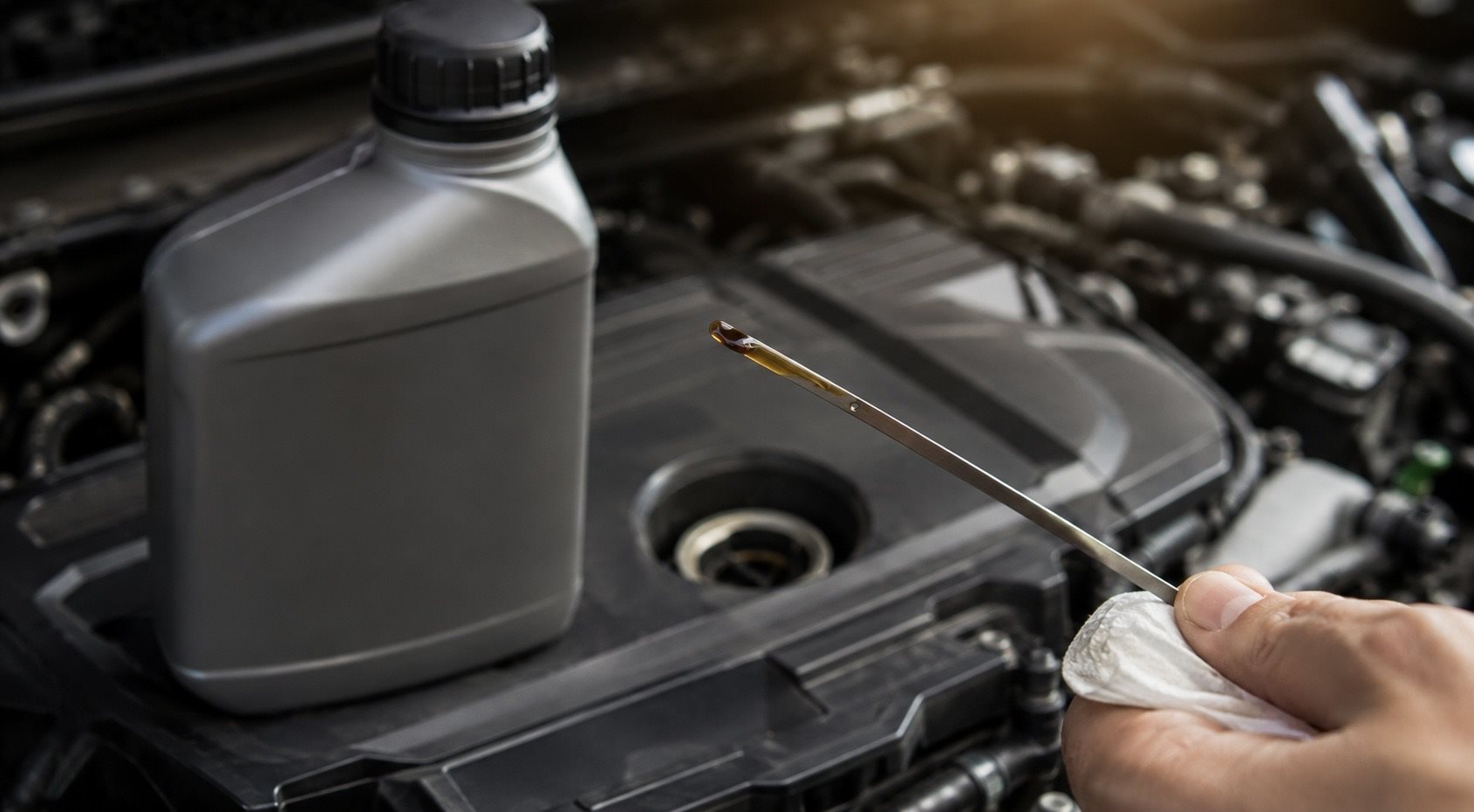 Checking engine oil level and grade on a dipstick