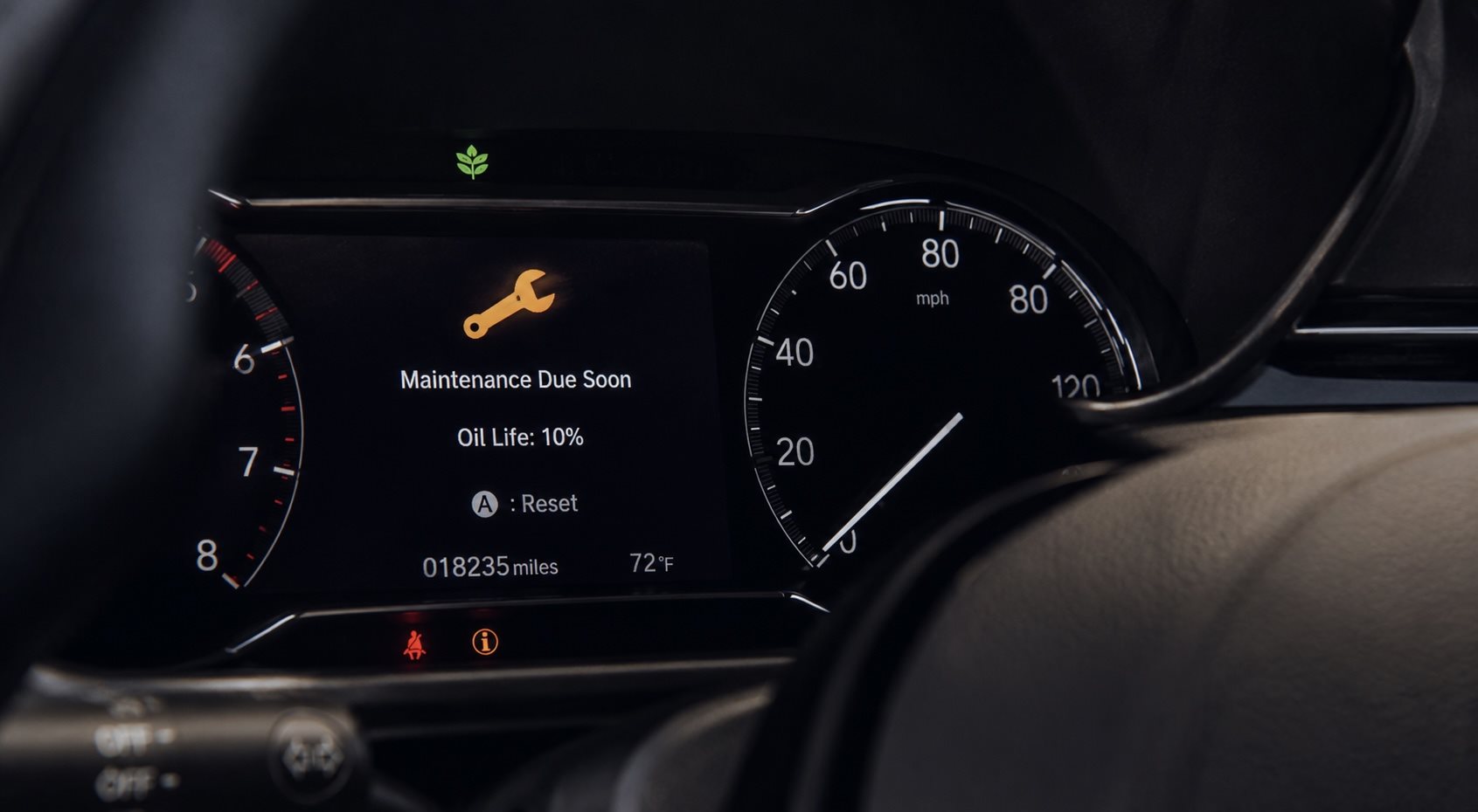 Maintenance reminder and oil-life indicator illuminated on a vehicle instrument cluster