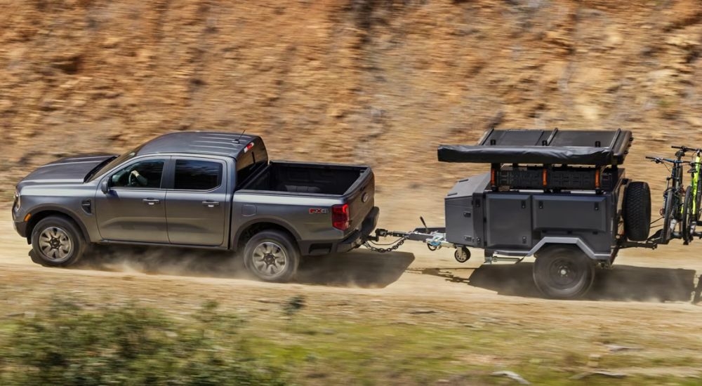 A gray 2026 Ford Ranger Lariat towing a trailer.