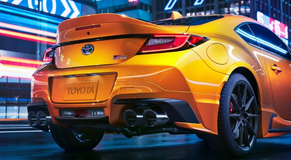 A yellow Yuzu Edition 2026 Toyota GR86 driving at night.
