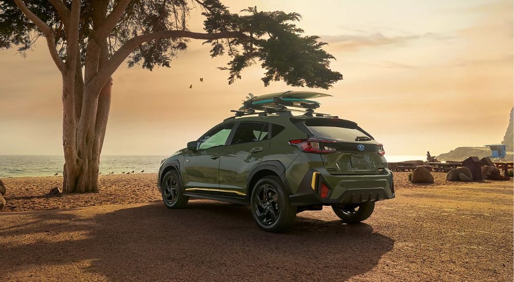 A green 2026 Subaru Crosstrek Sport parked at a beach.