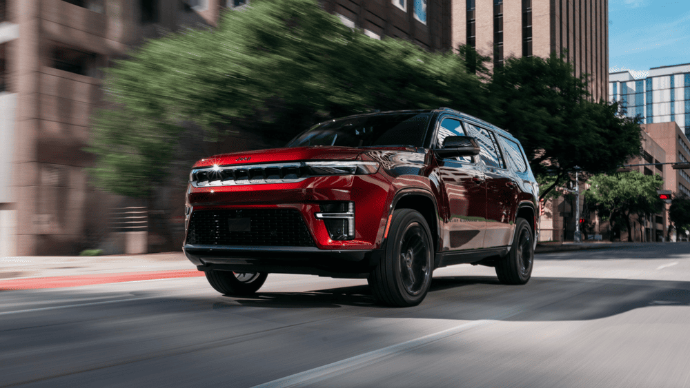 2026 Jeep Compass in Margate FL with fresh rally stripe hood design and LED headlights kicking up dust on a pine forest dirt trail, showcasing its efficient new appeal for Florida drivers