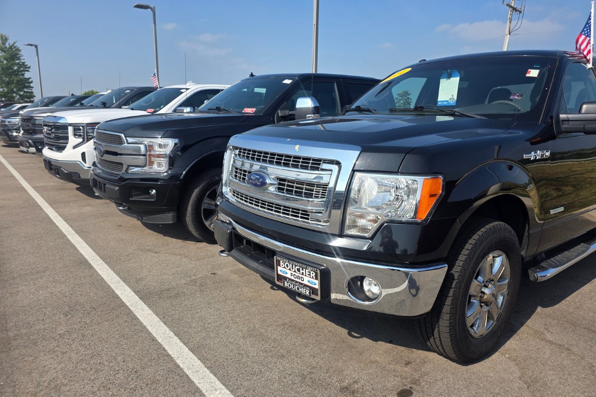 Rows of pre-owned Ford trucks displayed at Gordie Boucher Ford of Kenosha.