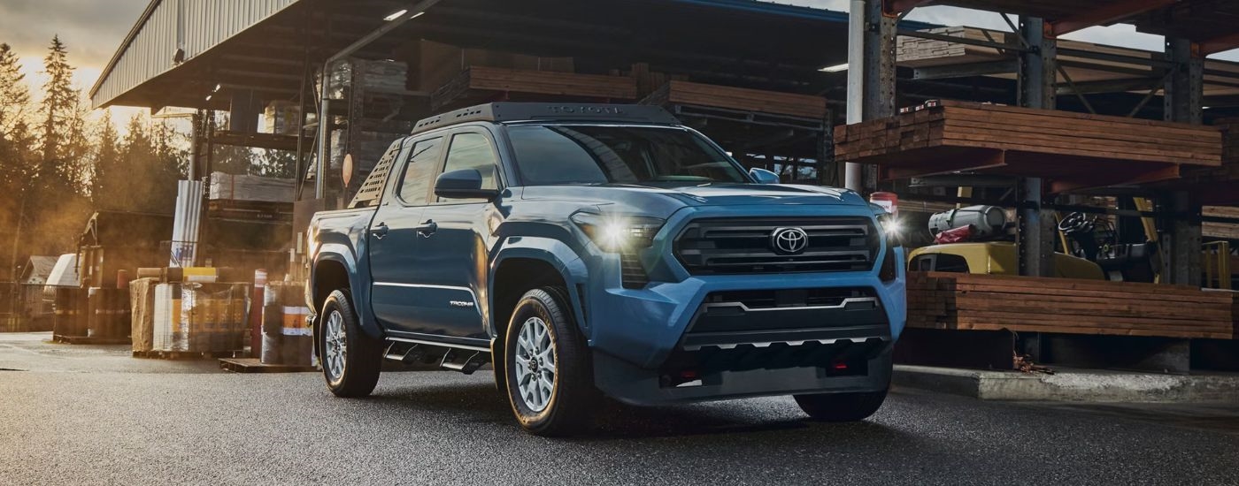 Blue 2026 Toyota Tacoma double cab parked in a lumber yard.