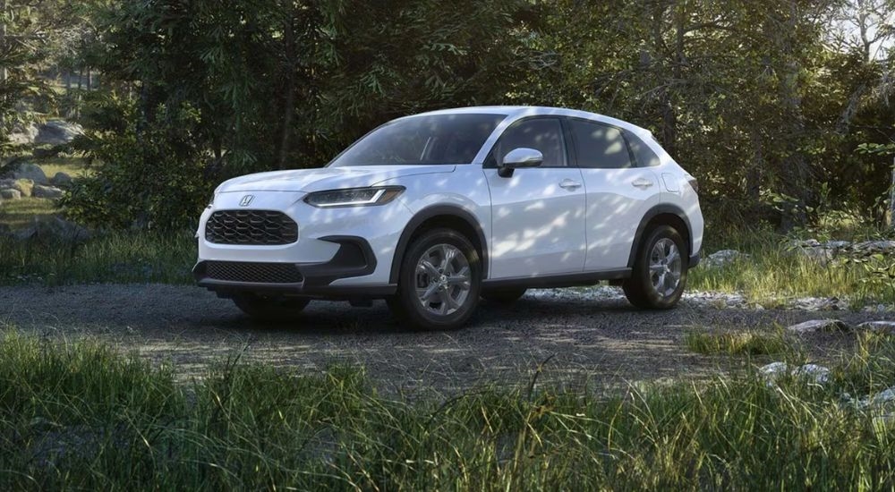 White 2027 Honda HR-V parked in a wooded area.