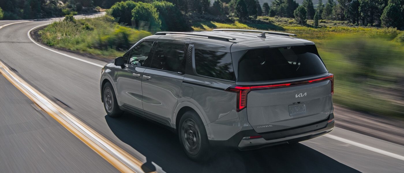 2026 Kia Carnival MPV driving away on highway