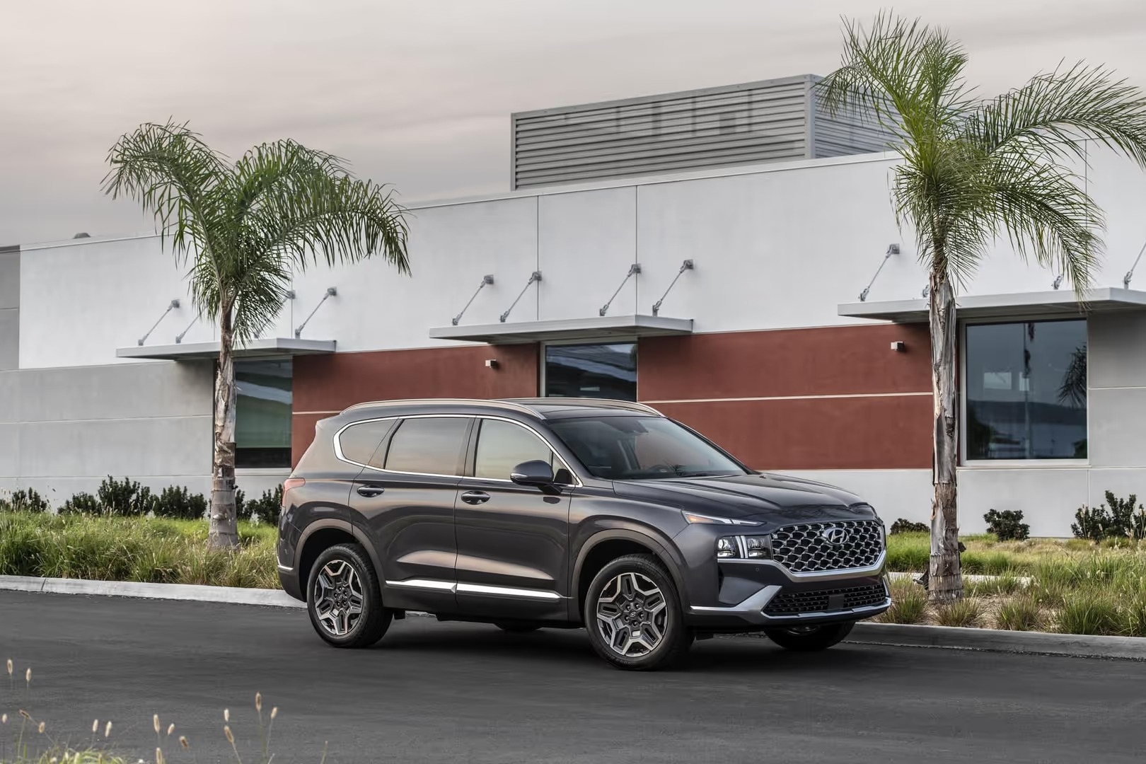 A 2023 Hyundai Santa Fe compact SUV displayed in various colors, showcasing its modern design and versatility.