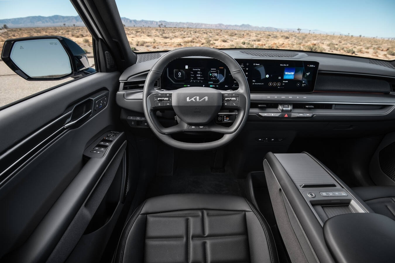Kia EV9 interior with three rows of seating and large display screens