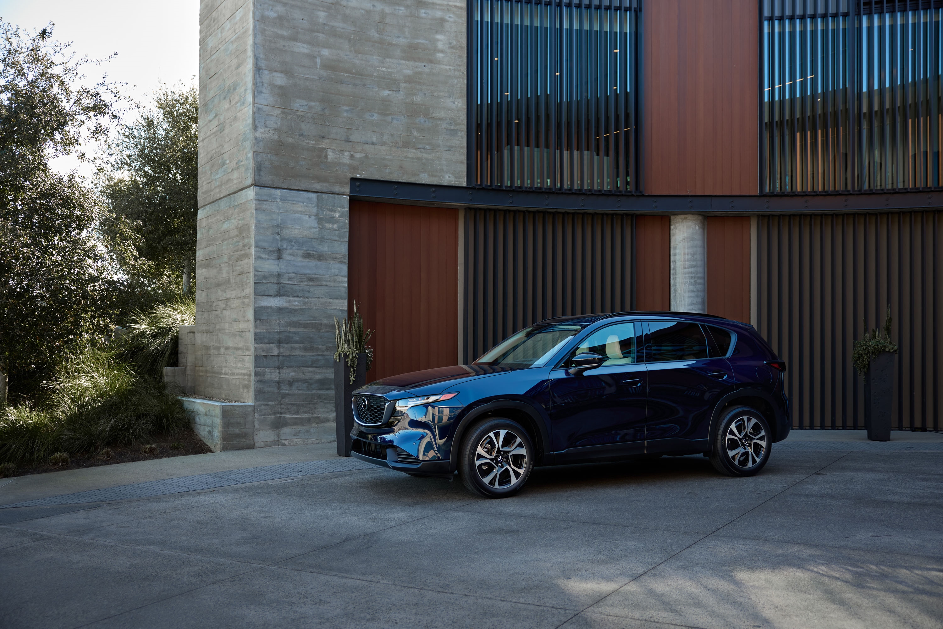 Tustin Mazda team helping a family compare Mazda safety ratings and features