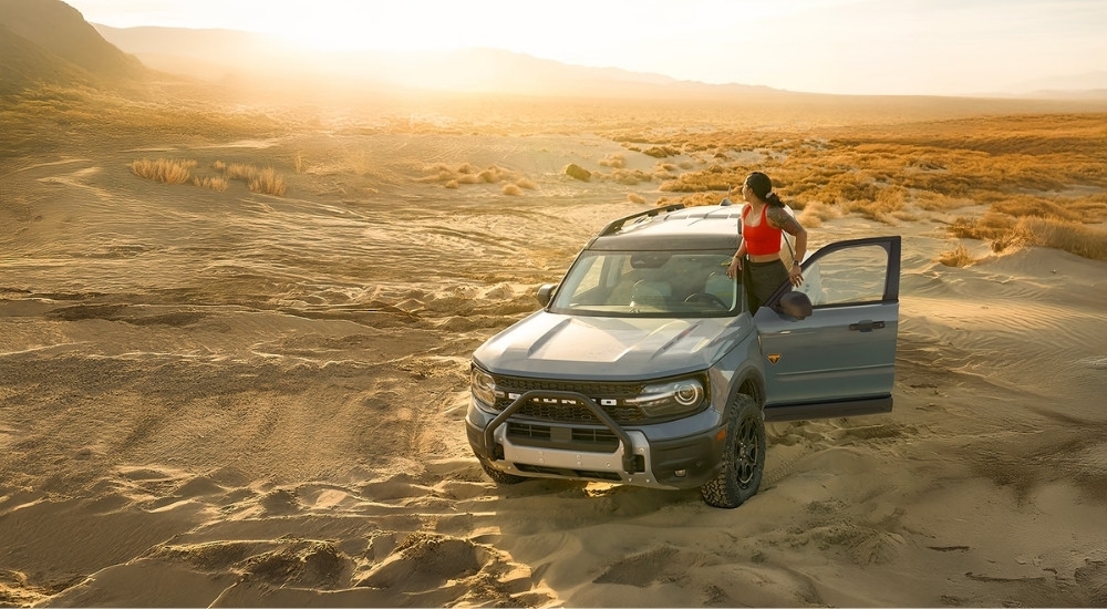 A blue 2026 Ford Bronco Sport Badlands parked on sand.