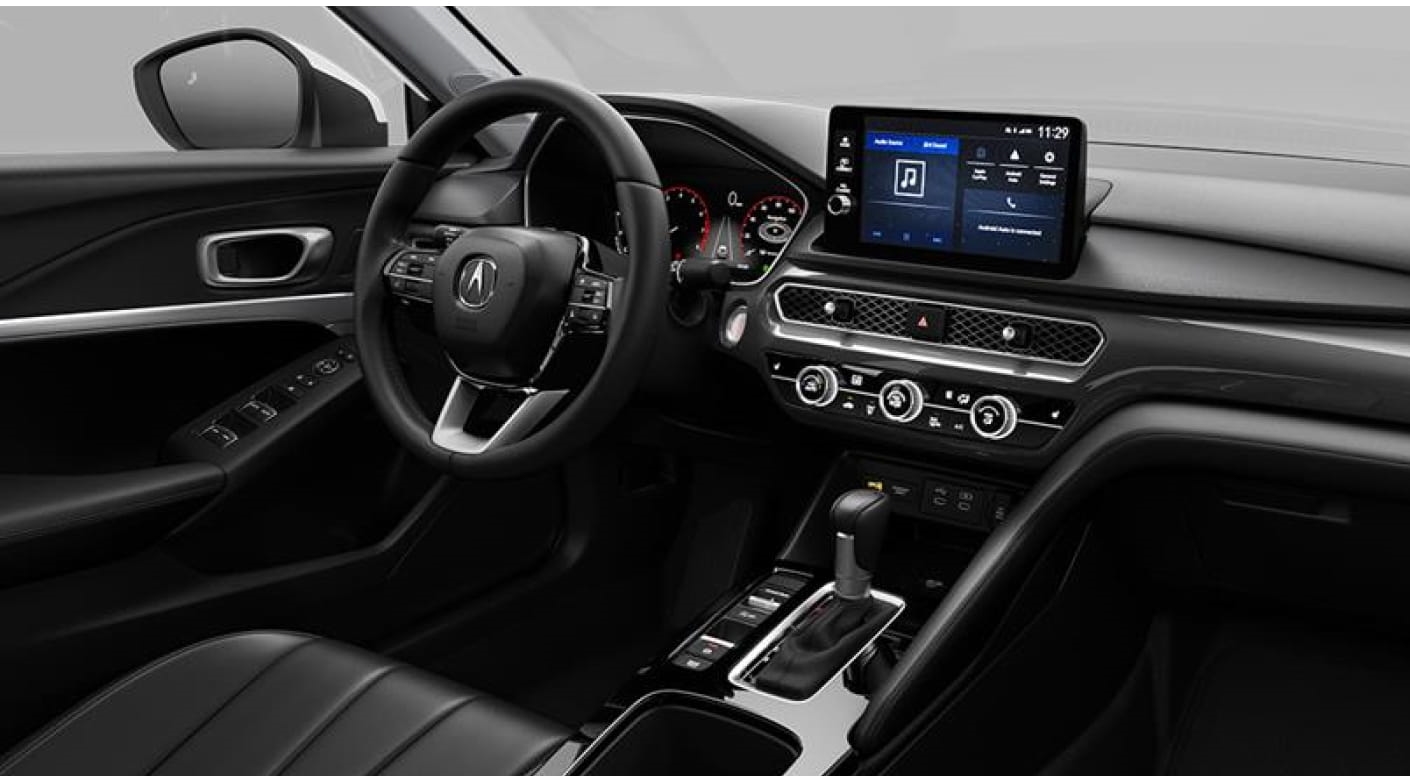 Acura Integra interior featuring a multifunction steering wheel, digital instrument cluster, touchscreen display, and center console.