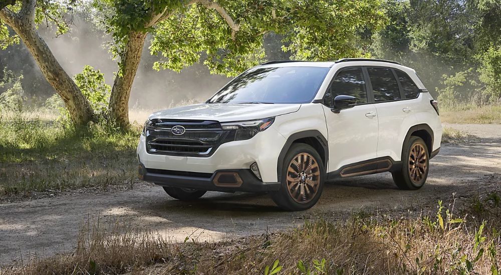 White 2026 Subaru Forester Sport parked in the trees.