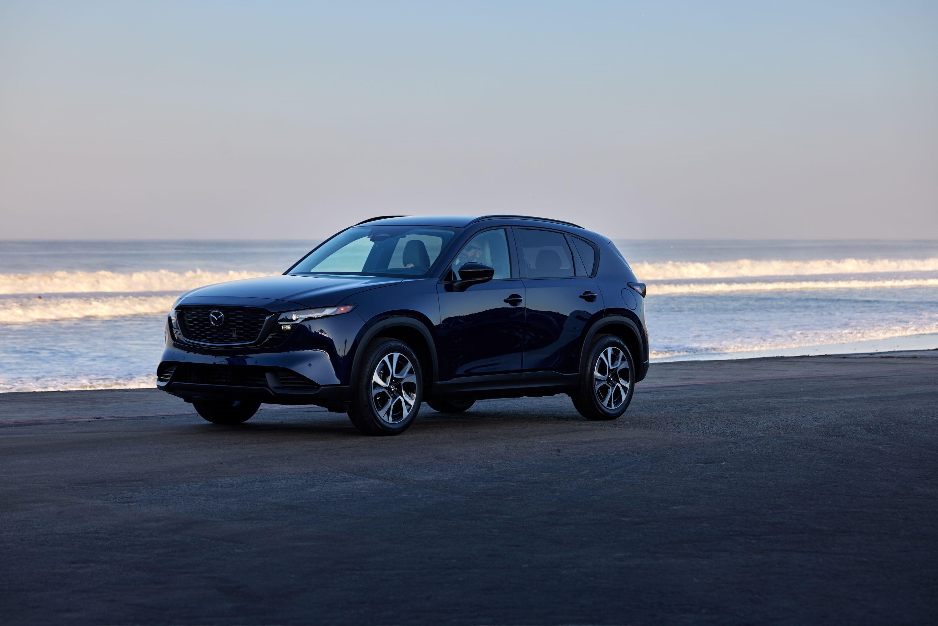 Family with a Mazda CX-5 reviewing i-Activsense safety features at Patterson Autos