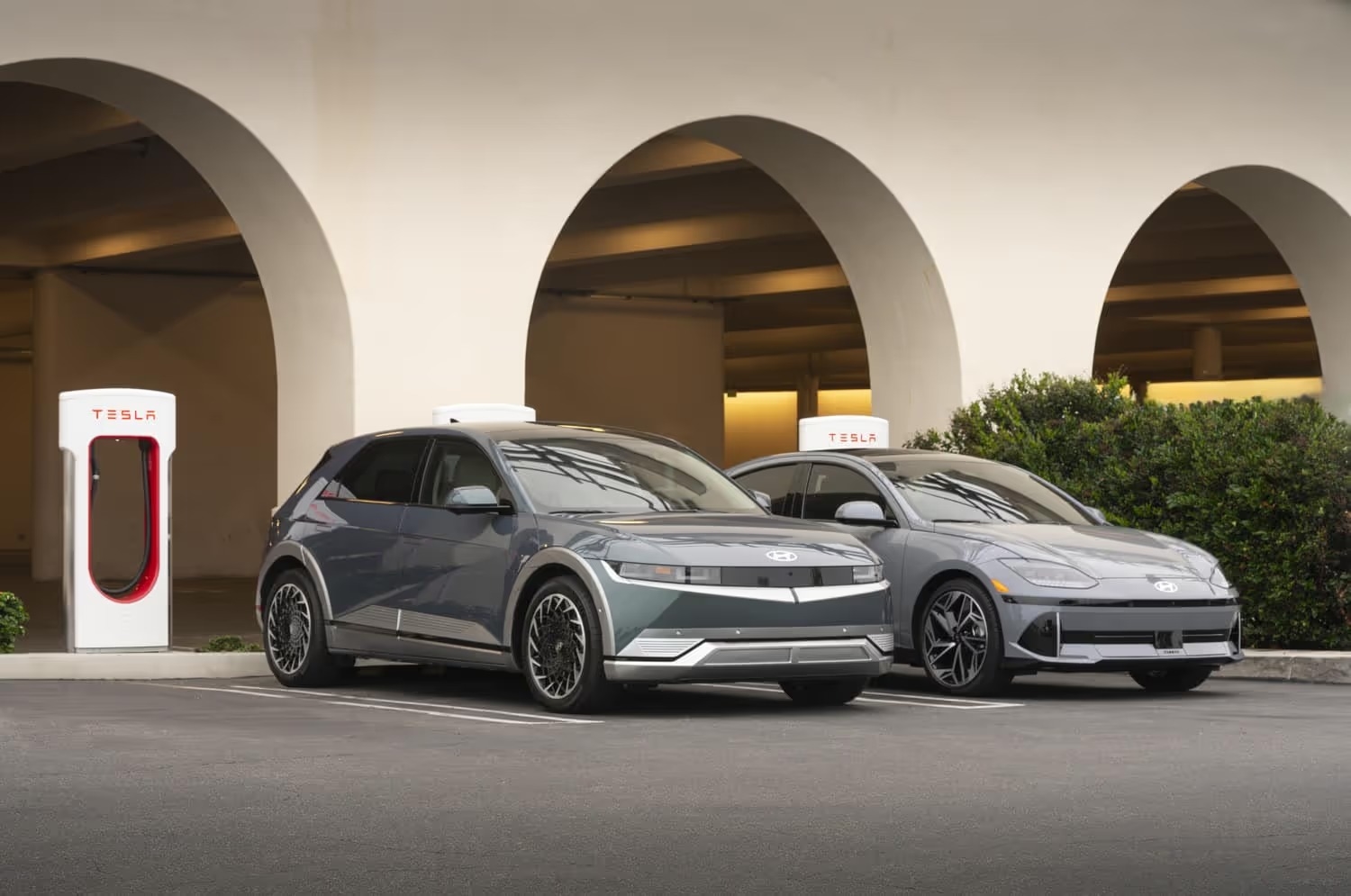 Hyundai IONIQ 5 and IONIQ 6 in front of charging station