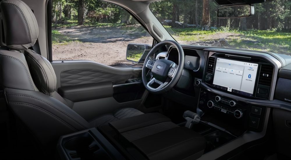 Interior view of a 2026 Ford F-150 Platinum parked in woods.