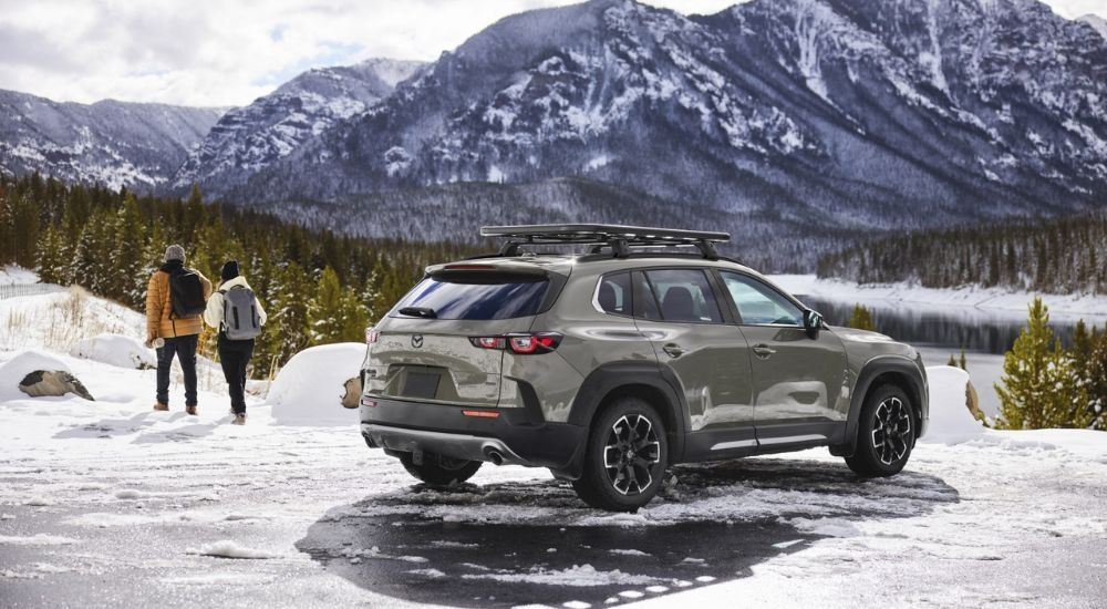 People walking away from a green 2026 Mazda CX-50.