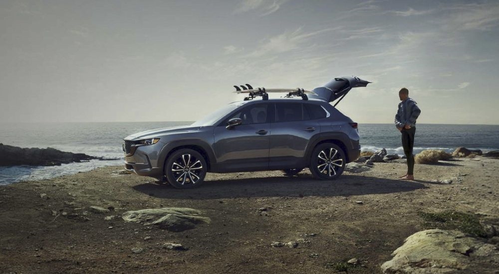 Rear gate open on the beach on a gray 2026 Mazda CX-50.