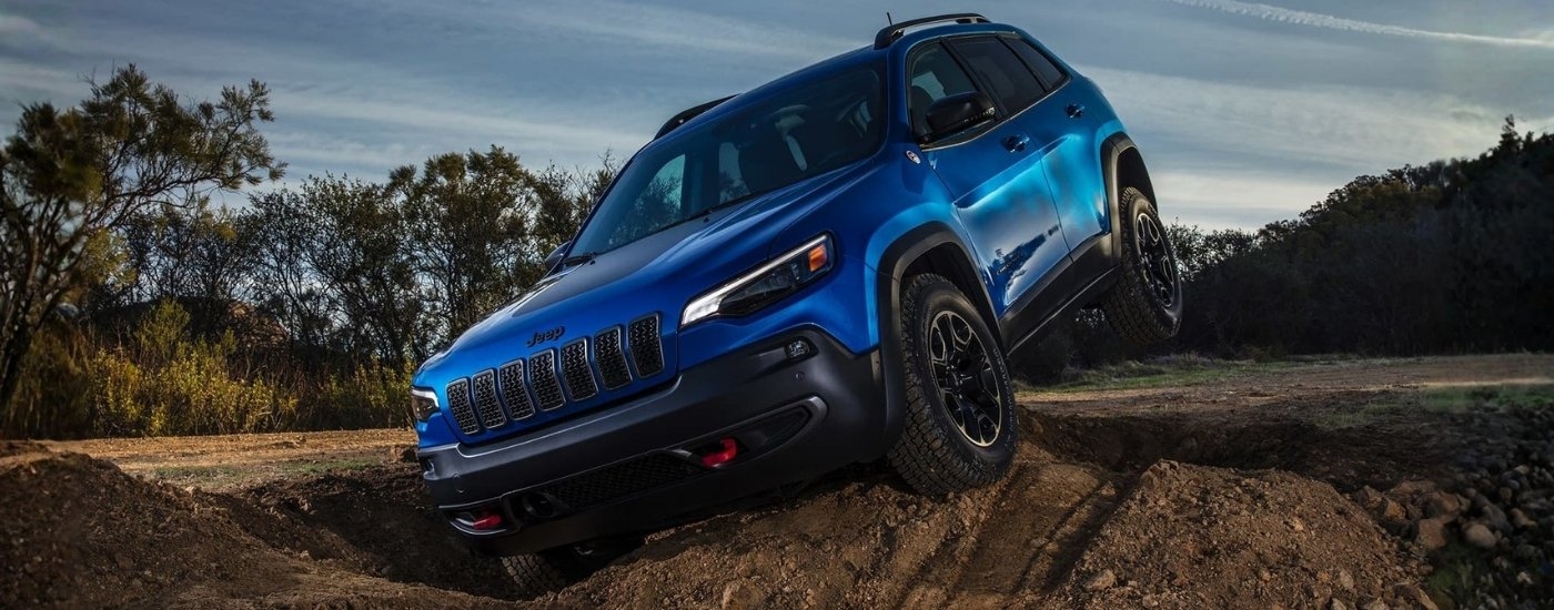 Blue 2020 Jeep Cherokee Trailhawk driving on a trail