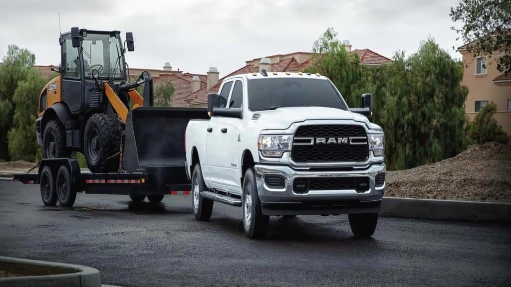 white dodge ram 2500 tradesman towing construction equipment