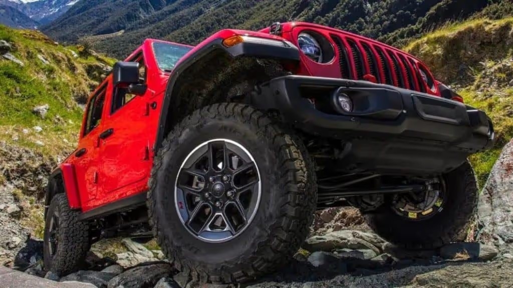 2022 red jeep wangler climbing up a hill showcasing the vehicles tires
