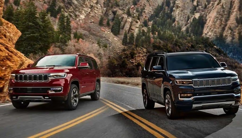 comparison image of a red 2022 jeep wagoneer versus a black 2022 jeep grand wagoneer on the road