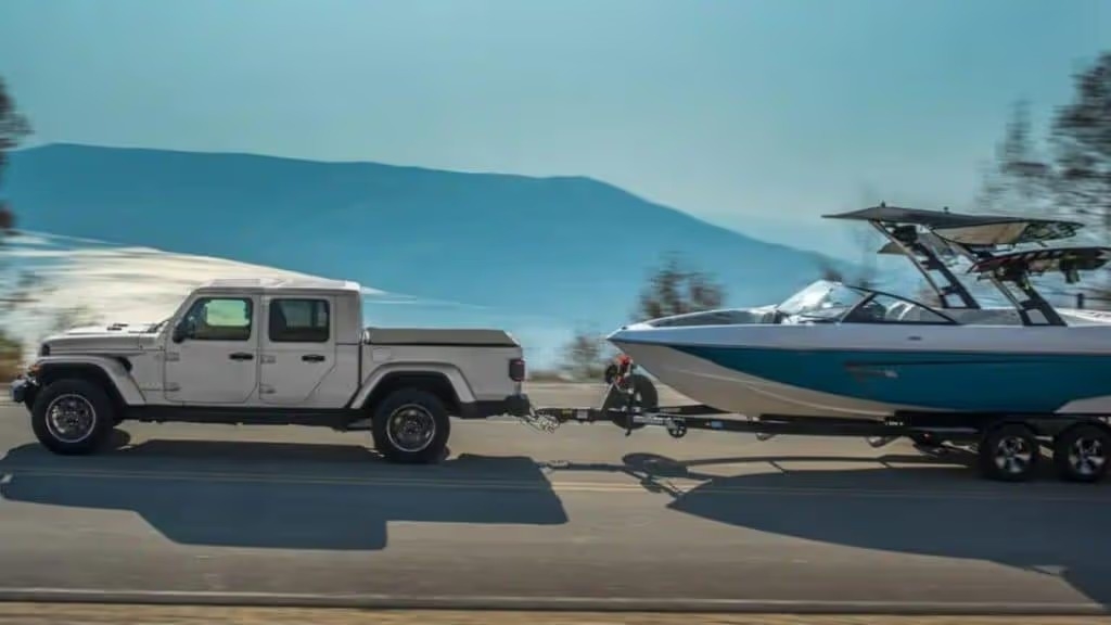 2022 jeep gladiator towing a boat on the road